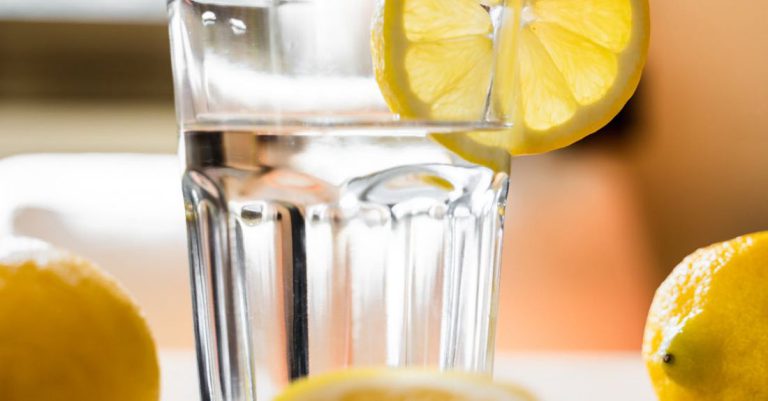 Detox Energy - Glass of cold water with lemon placed on table
