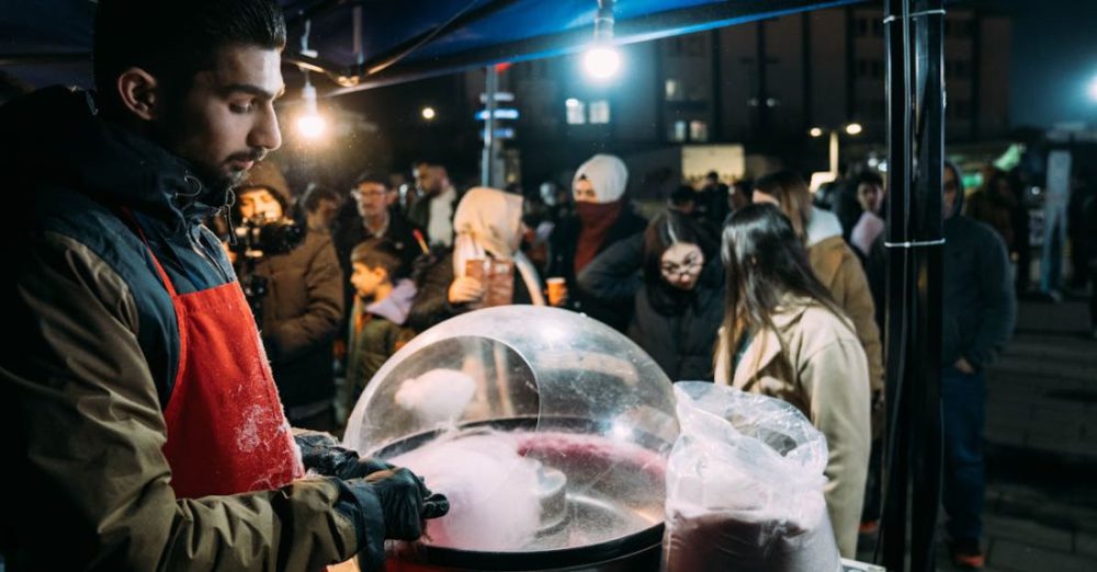 Sugar Intake - A man in an apron is making a snow cone