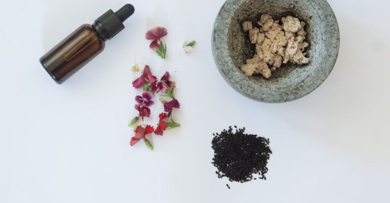 Skincare Ingredients - Black Seeds, Fresh Flowers, A Bottle and A Mortar