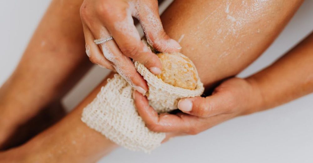 Exfoliating - Person Using a Body Scrub on Legs